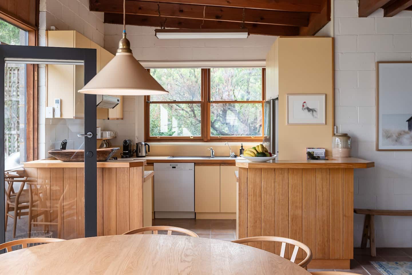 The kitchen, with timber cabinets and a window onto the garden